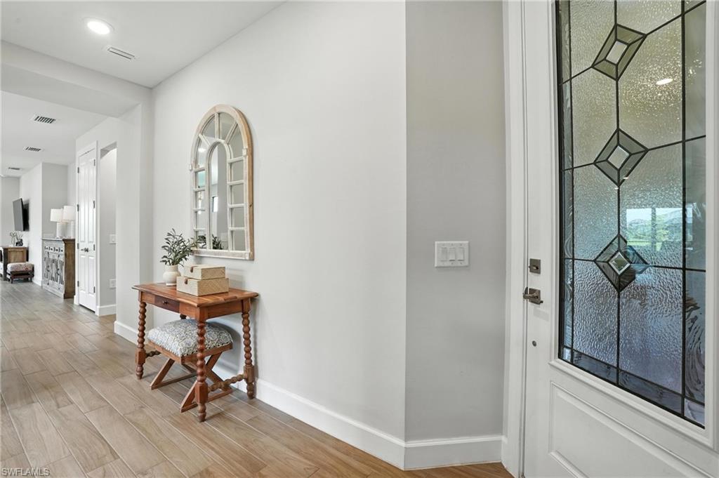 11945 Sacra Place Fort Myers, FL 33913 - Photo 5 of 50 Entryway featuring baseboards and light wood-type flooring