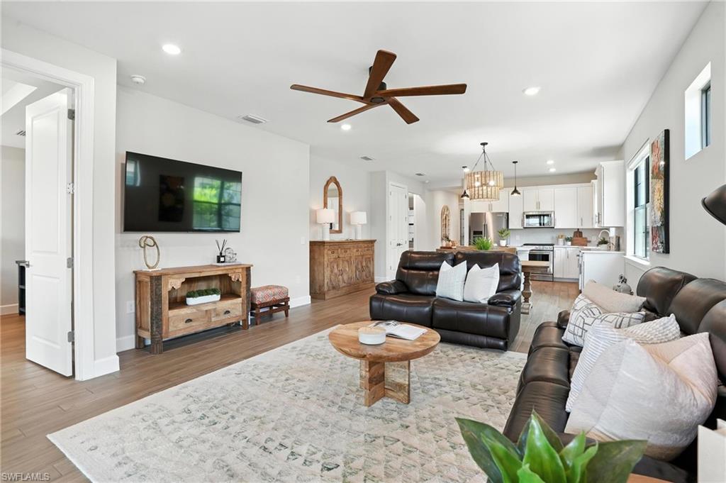 11945 Sacra Place Fort Myers, FL 33913 - Photo 9 of 50 Living area featuring light wood-style floors, ceiling fan, recessed lighting, and a chandelier