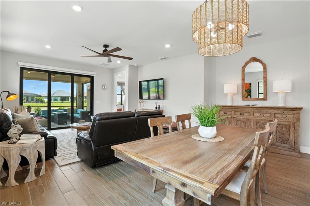 11945 Sacra Place Fort Myers, FL 33913 - Photo 10 of 50 Dining room with light wood finished floors, recessed lighting, ceiling fan, and a chandelier