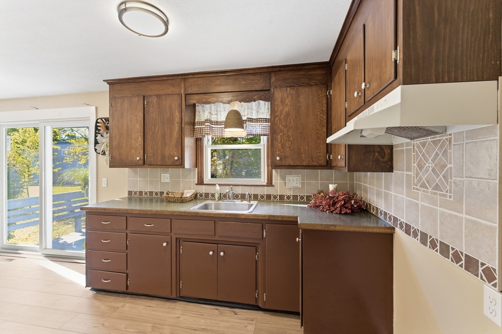 22 Phelps Street Easthampton, MA 01027 - Photo 13 of 42 a kitchen with a sink and wooden cabinets