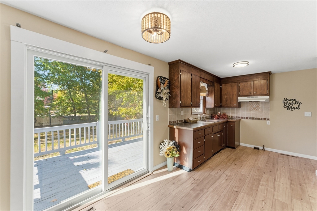 22 Phelps Street Easthampton, MA 01027 - Photo 14 of 42 a view of a kitchen with wooden floor and stainless steel appliances