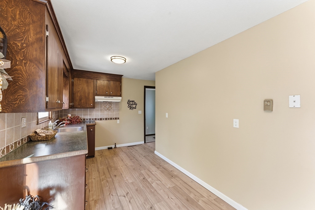 22 Phelps Street Easthampton, MA 01027 - Photo 16 of 42 a kitchen with a refrigerator and a stove top oven