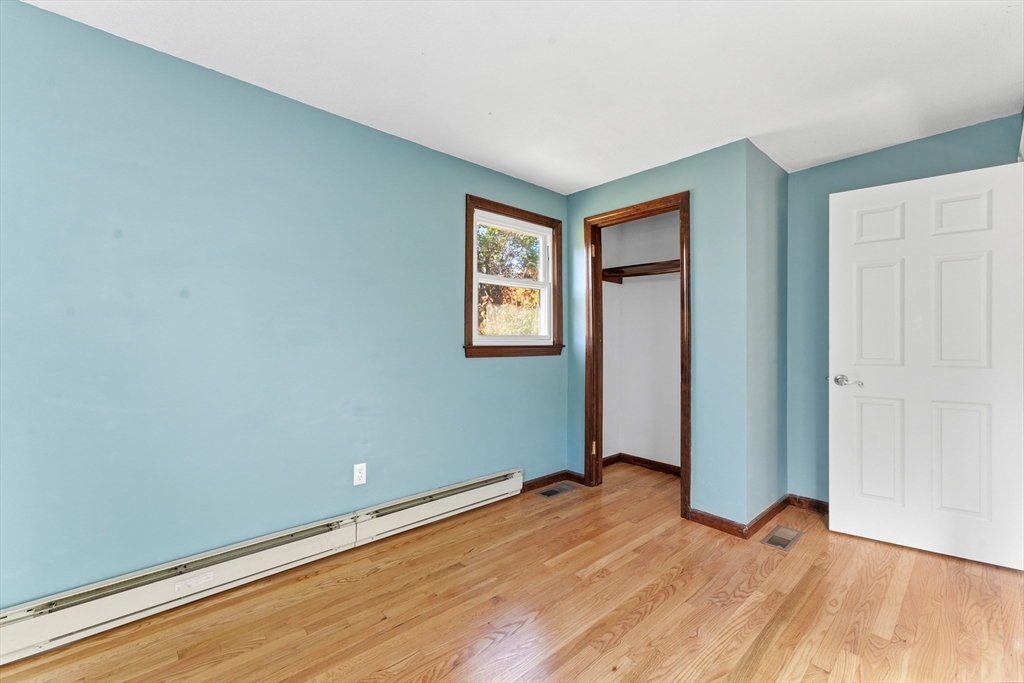 22 Phelps Street Easthampton, MA 01027 - Photo 24 of 42 an empty room with wooden floor and windows