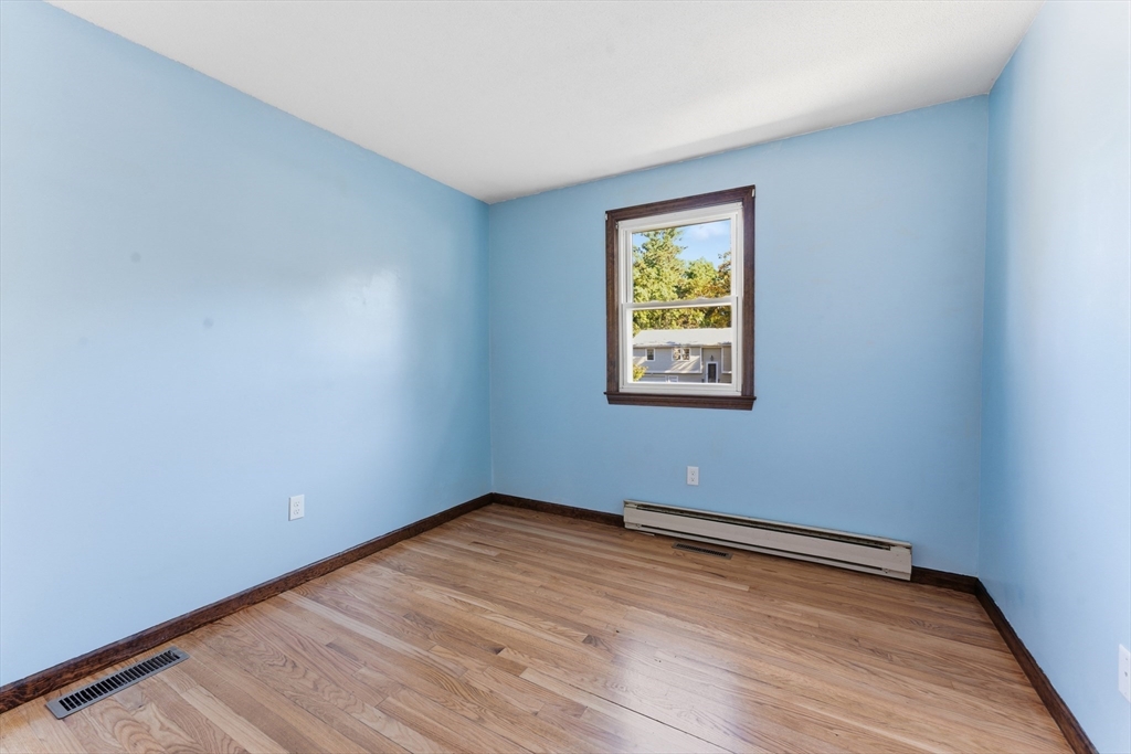 22 Phelps Street Easthampton, MA 01027 - Photo 28 of 42 a view of an empty room with wooden floor and a window