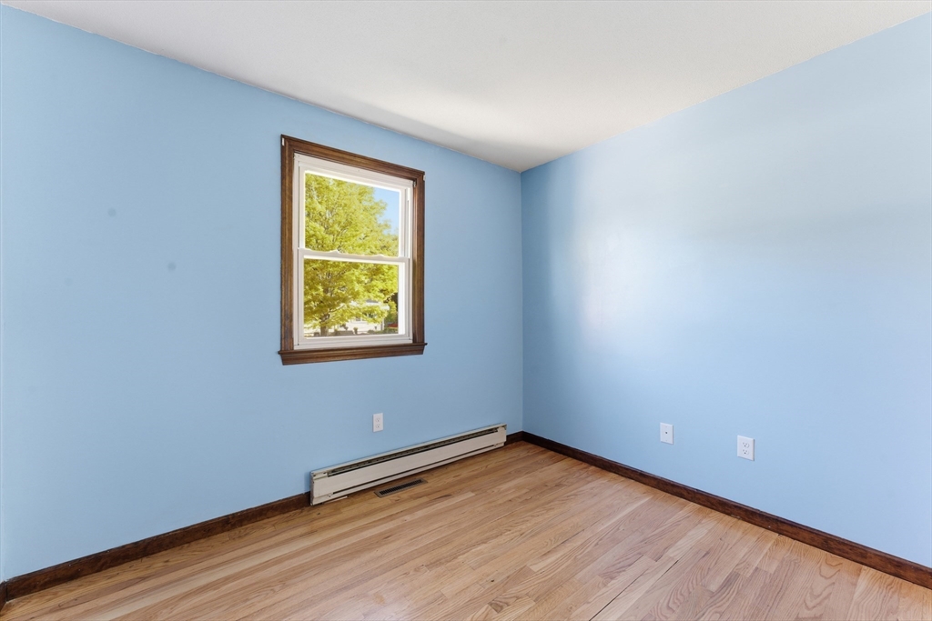 22 Phelps Street Easthampton, MA 01027 - Photo 29 of 42 wooden floor in an empty room with a window