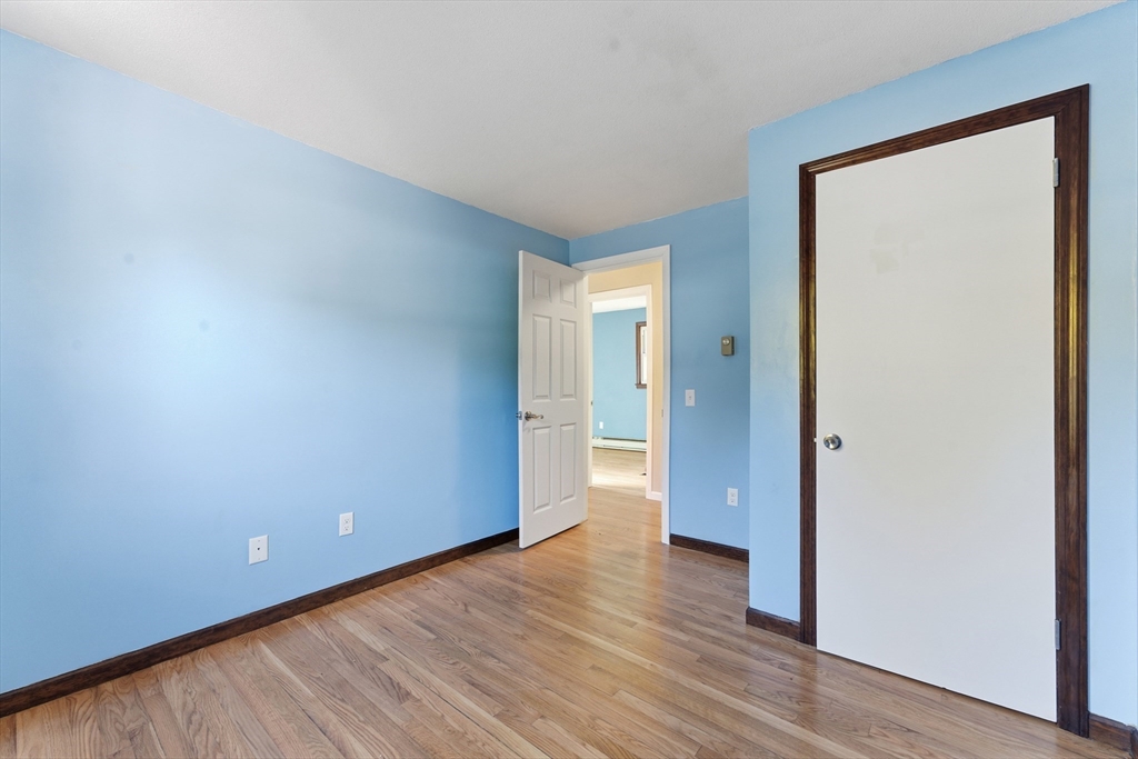 22 Phelps Street Easthampton, MA 01027 - Photo 30 of 42 a view of an empty room with wooden floor and a window