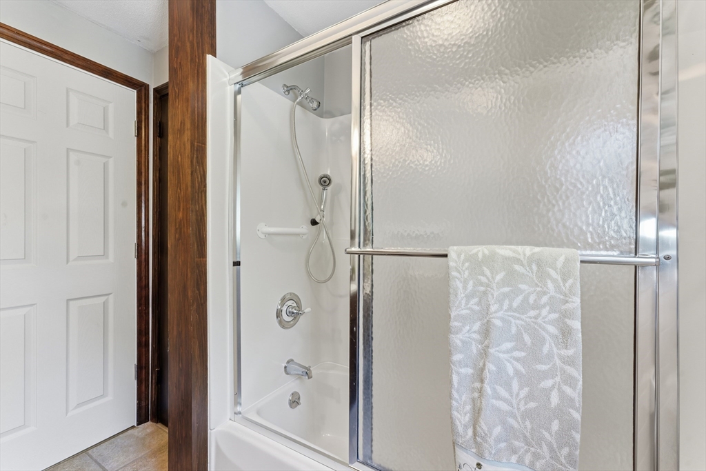 22 Phelps Street Easthampton, MA 01027 - Photo 32 of 42 a bathroom with a glass shower door