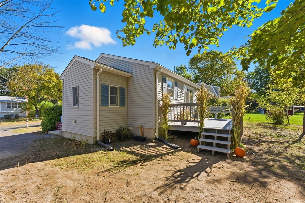 22 Phelps Street Easthampton, MA 01027 - Photo 41 of 42 a view of backyard with a table and chair and barbeque grill with wooden fence