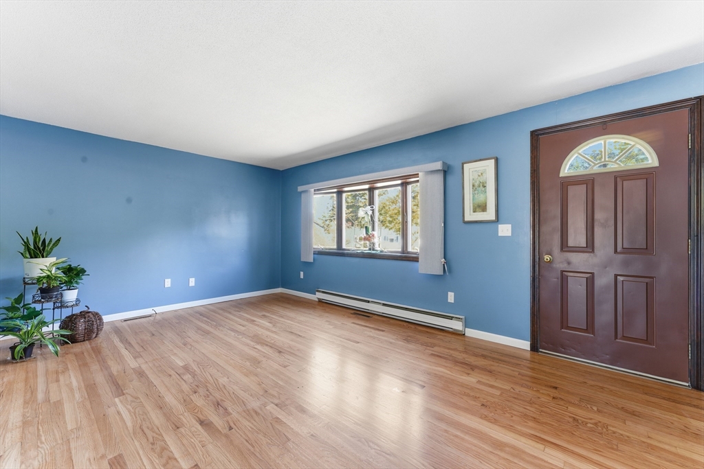 22 Phelps Street Easthampton, MA 01027 - Photo 7 of 42 a view of an empty room with a window and wooden floor