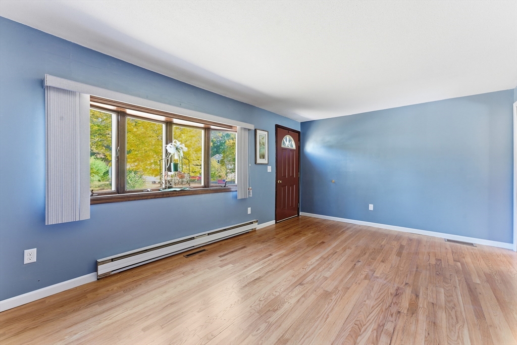 22 Phelps Street Easthampton, MA 01027 - Photo 8 of 42 a view of an empty room with wooden floor and a window
