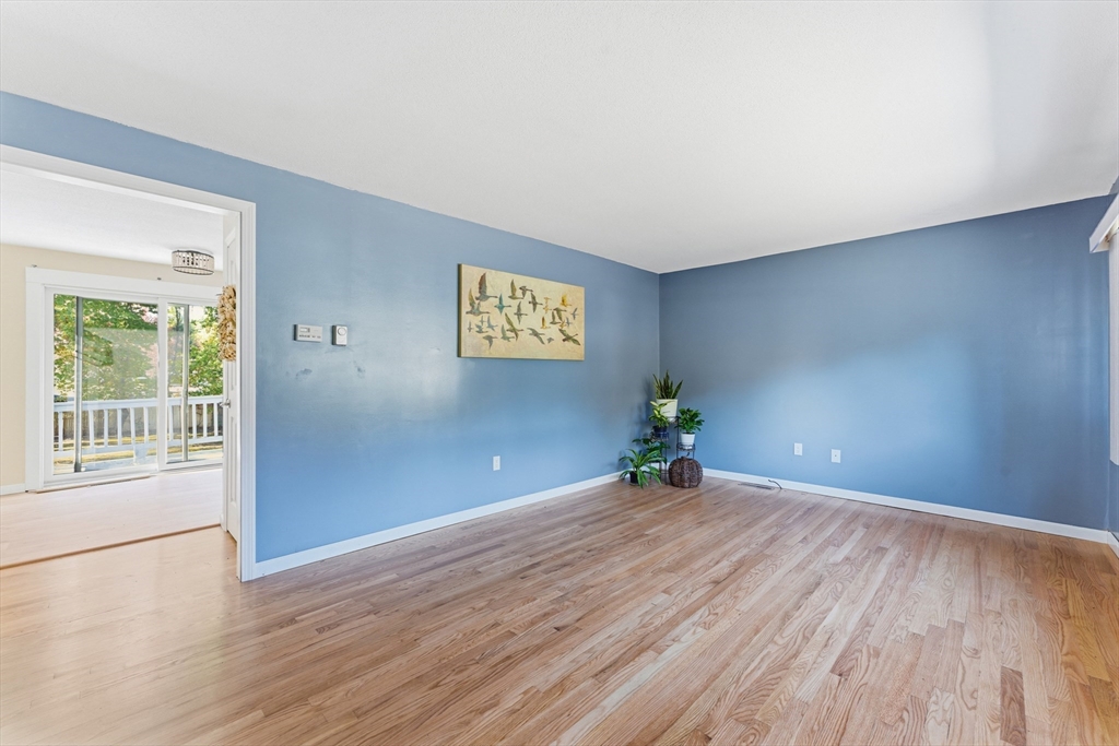 22 Phelps Street Easthampton, MA 01027 - Photo 10 of 42 a view of a big room with wooden floor and windows