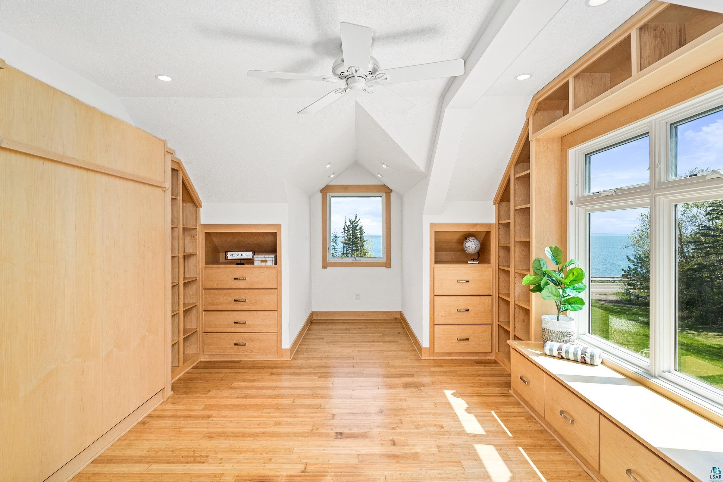 5163 Greenwood Road Duluth, MN 55804 - Photo 28 of 47 Room featuring hardwood flooring, built-in shelving, integrated drawers, a window seat with storage, and recessed lighting