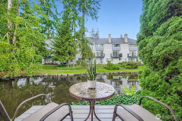 a view of a chairs and table in backyard