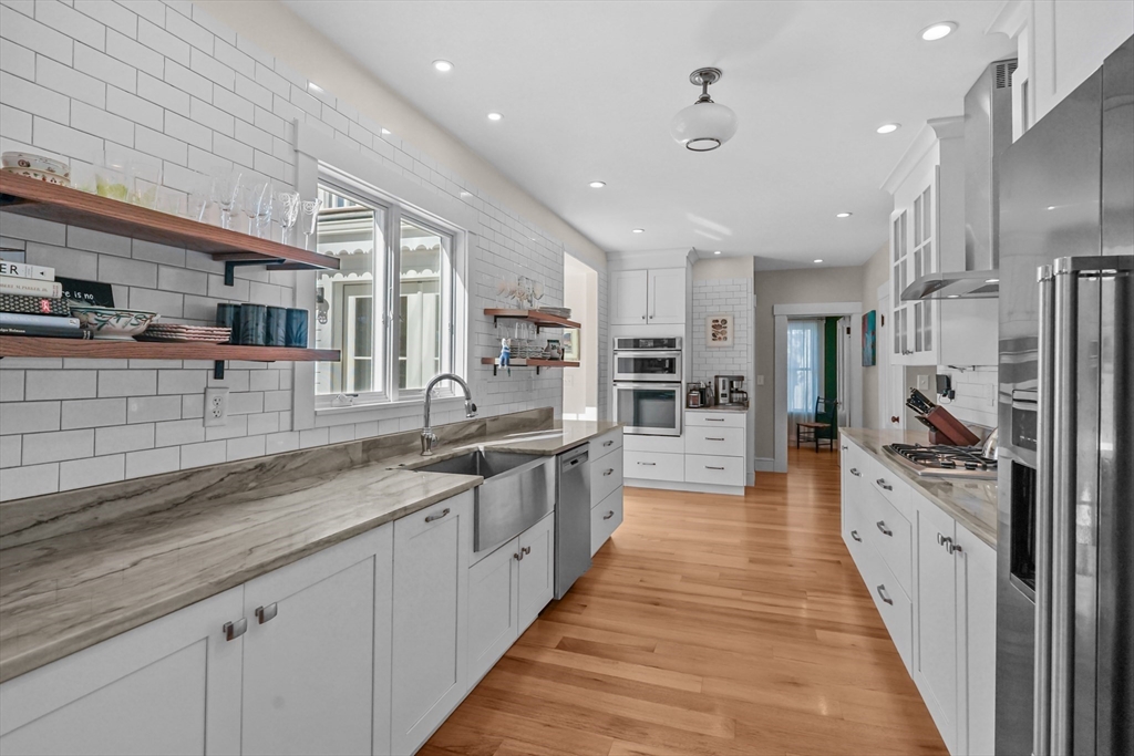 1881 Main Road Westport, MA 02791 - Photo 13 of 42 a large kitchen with stainless steel appliances lots of counter space and wooden floor
