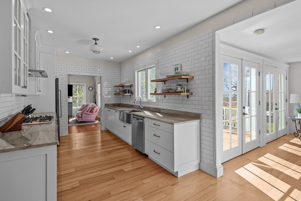 1881 Main Road Westport, MA 02791 - Photo 16 of 42 a large kitchen with stainless steel appliances granite countertop a lot of counter space and wooden floor