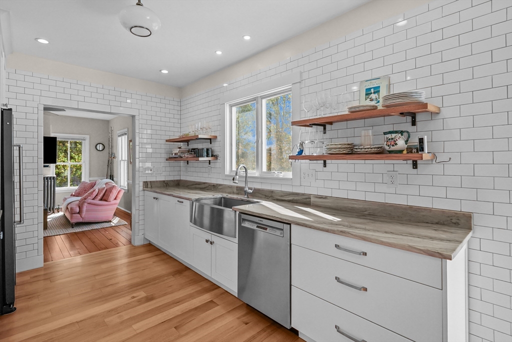 1881 Main Road Westport, MA 02791 - Photo 17 of 42 a kitchen with a sink stove and cabinets