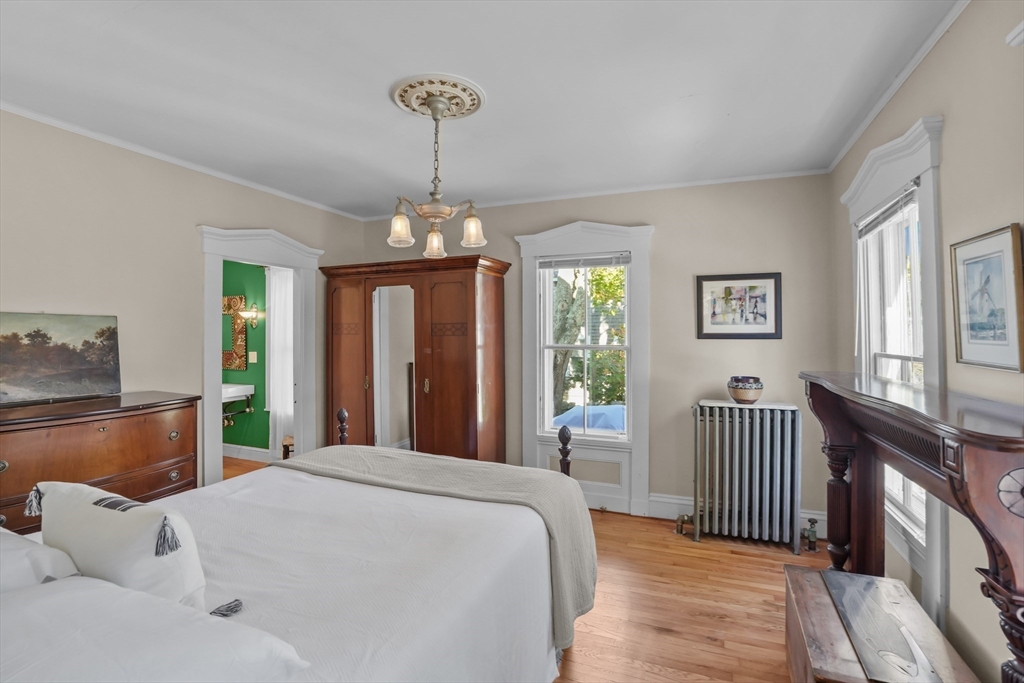 1881 Main Road Westport, MA 02791 - Photo 25 of 42 a bedroom with a bed and a chandelier