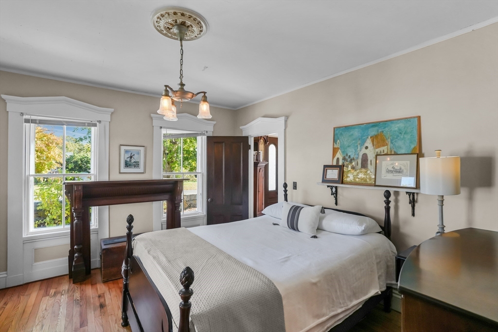 1881 Main Road Westport, MA 02791 - Photo 26 of 42 a bedroom with a bed and a table in it with window