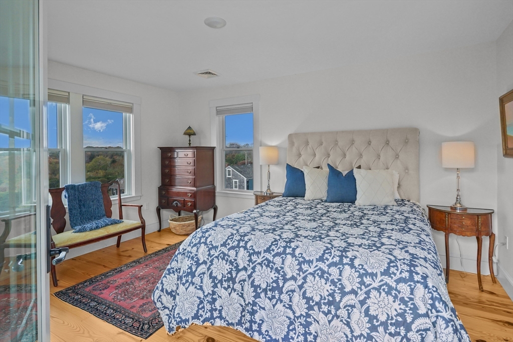 1881 Main Road Westport, MA 02791 - Photo 32 of 42 a bed sitting in a bedroom and a table in a bedroom