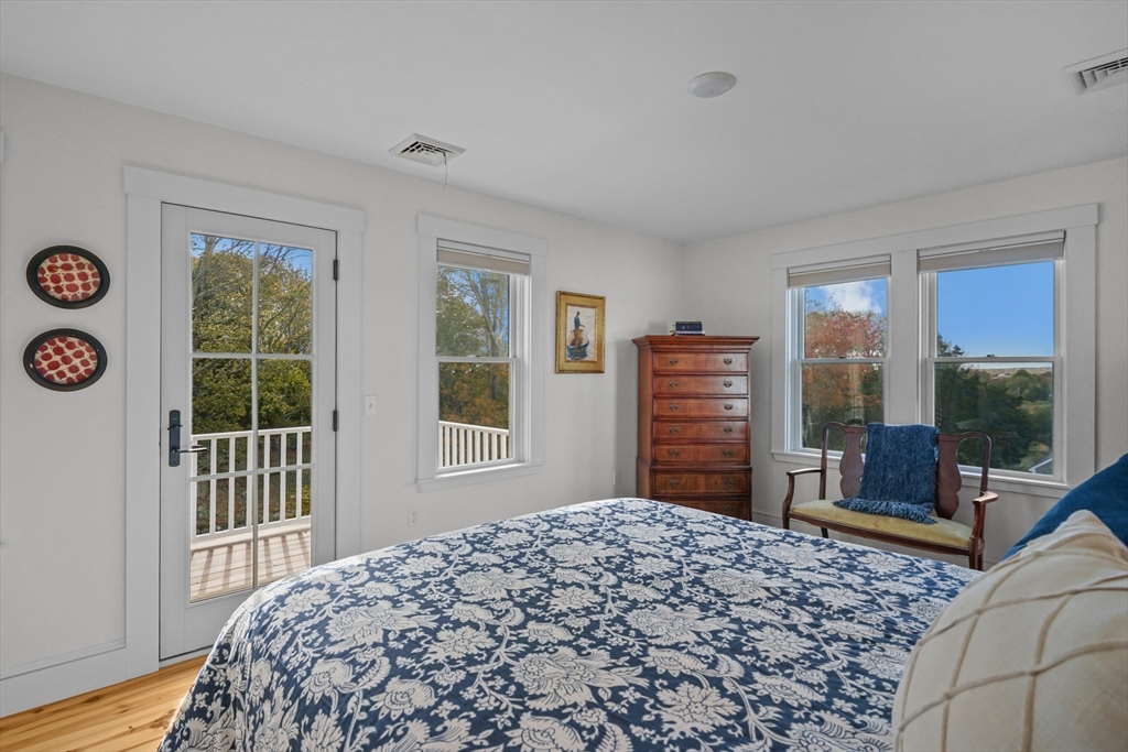 1881 Main Road Westport, MA 02791 - Photo 33 of 42 a bedroom with a bed and wooden floor