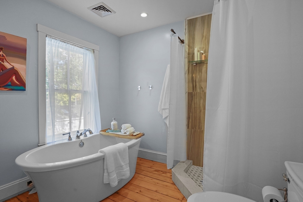 1881 Main Road Westport, MA 02791 - Photo 36 of 42 a bathroom with a white tub shower sink and a toilet