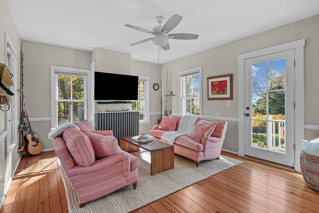 1881 Main Road Westport, MA 02791 - Photo 7 of 42 a living room with furniture a flat screen tv and a large window