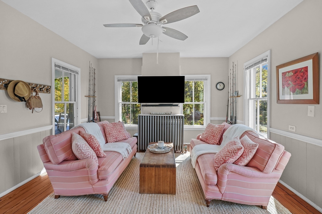 1881 Main Road Westport, MA 02791 - Photo 9 of 42 a living room with furniture a flat screen tv and a window
