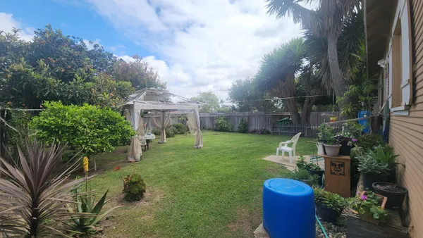 a view of a house with a yard and sitting area
