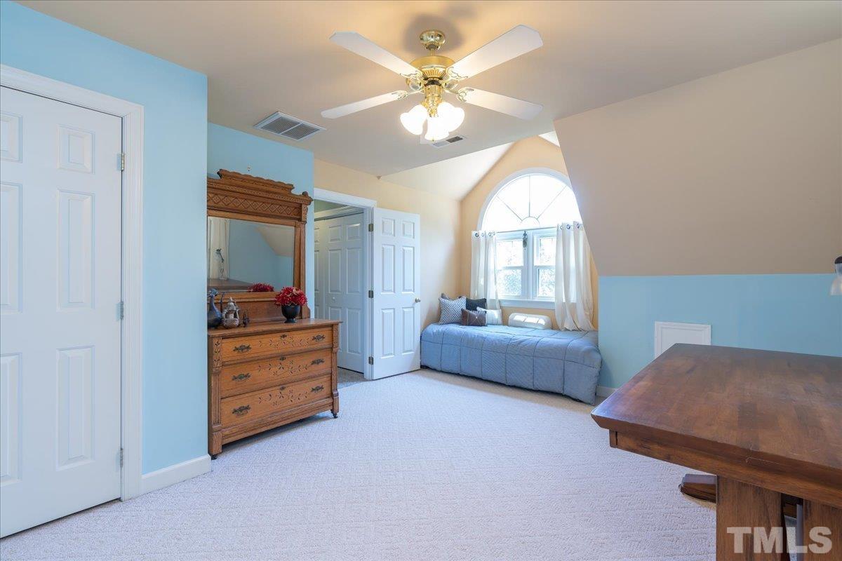 908 Broadhaven Drive Raleigh, NC 27603 - Photo 18 of 33 a living room with furniture and a chandelier