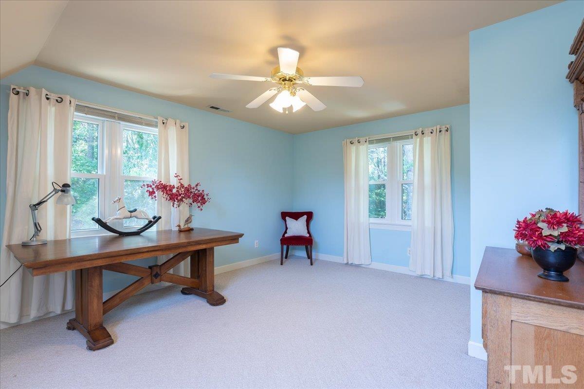908 Broadhaven Drive Raleigh, NC 27603 - Photo 19 of 33 a living room with furniture and a chandelier