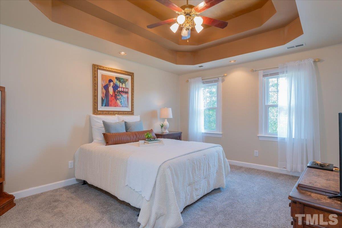 908 Broadhaven Drive Raleigh, NC 27603 - Photo 20 of 33 a bedroom with a bed and a chandelier