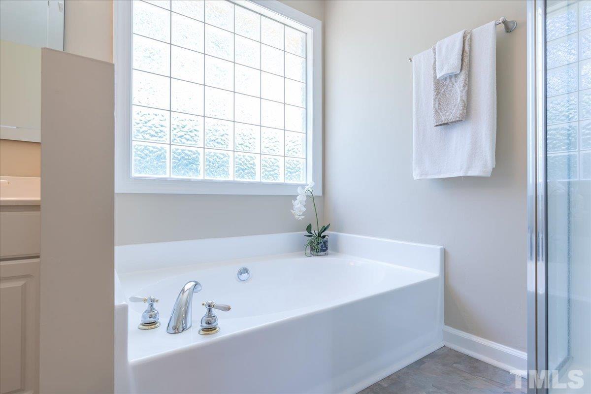 908 Broadhaven Drive Raleigh, NC 27603 - Photo 22 of 33 a bathroom with a bathtub and a window