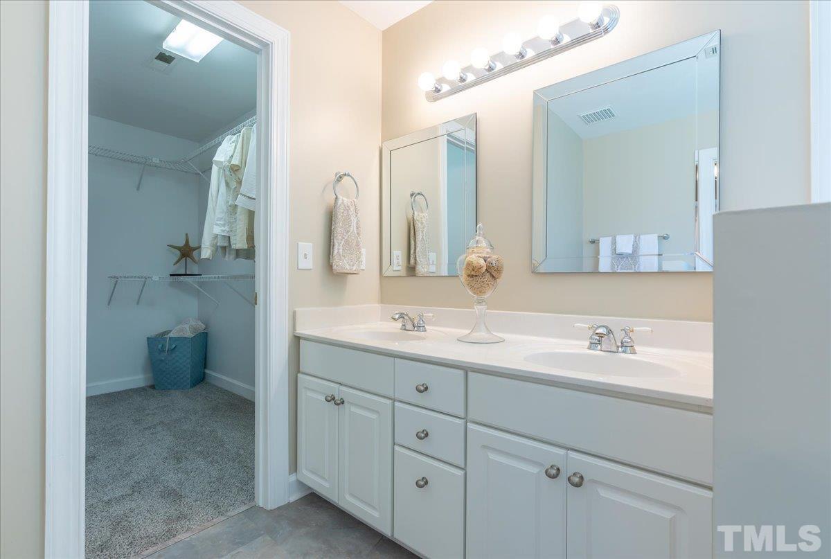 908 Broadhaven Drive Raleigh, NC 27603 - Photo 23 of 33 a bathroom with a double vanity sink mirror and toilet