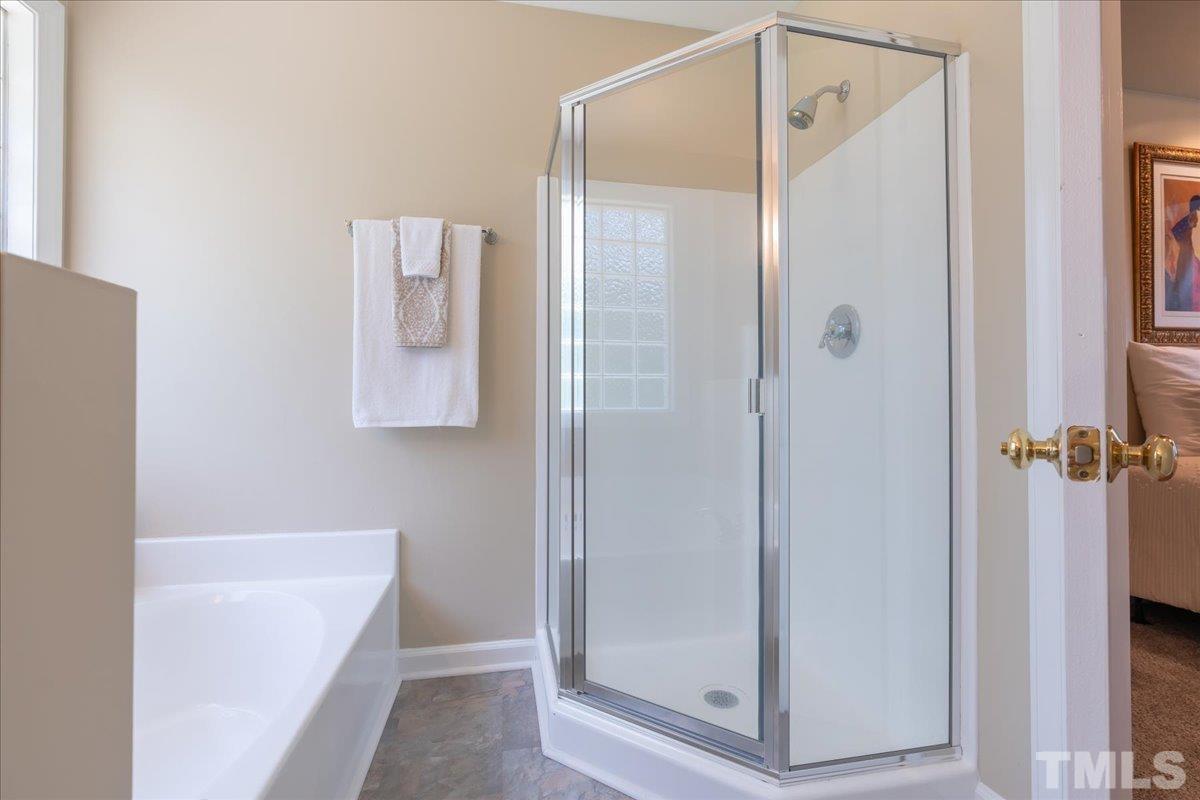 908 Broadhaven Drive Raleigh, NC 27603 - Photo 24 of 33 a bathroom with a shower and a tub