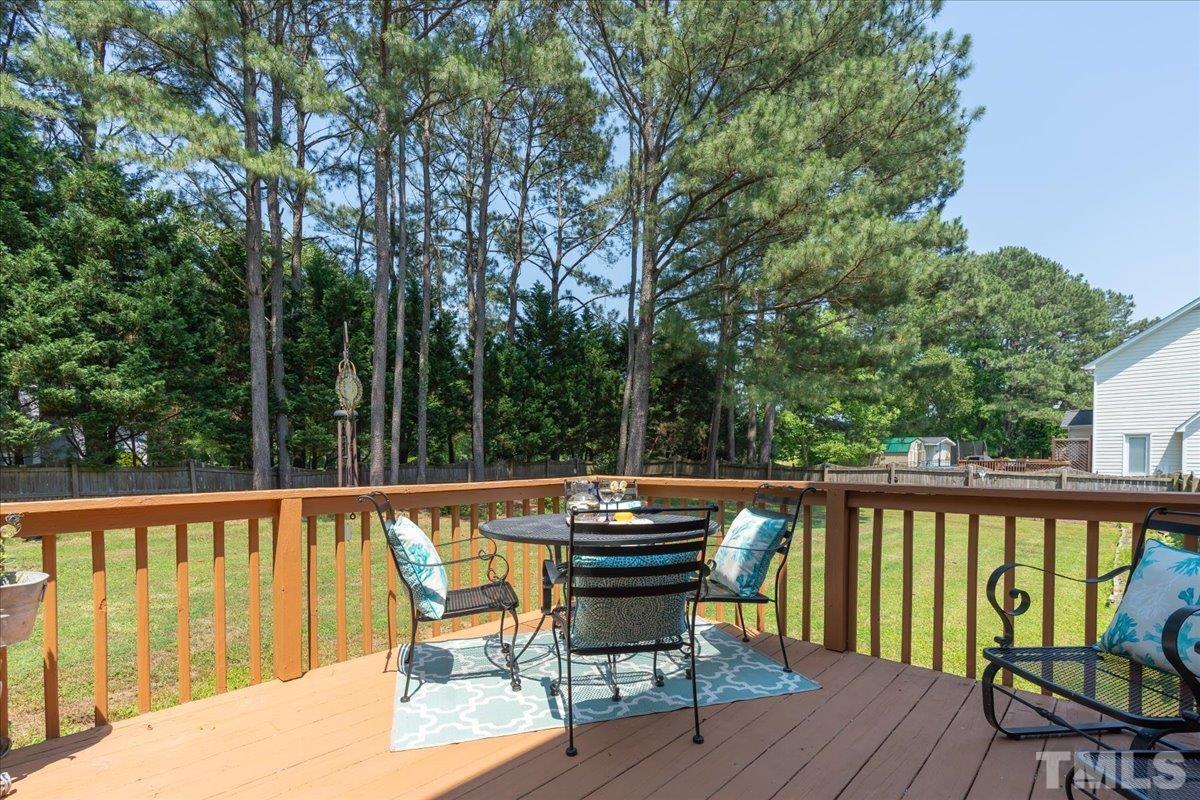 908 Broadhaven Drive Raleigh, NC 27603 - Photo 25 of 33 a view of a patio with wooden floor and outdoor seating