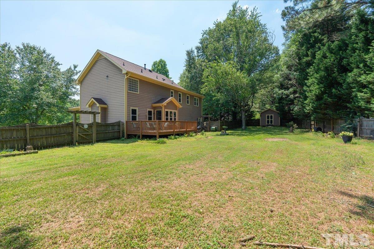 908 Broadhaven Drive Raleigh, NC 27603 - Photo 30 of 33 a view of a house with backyard and trees