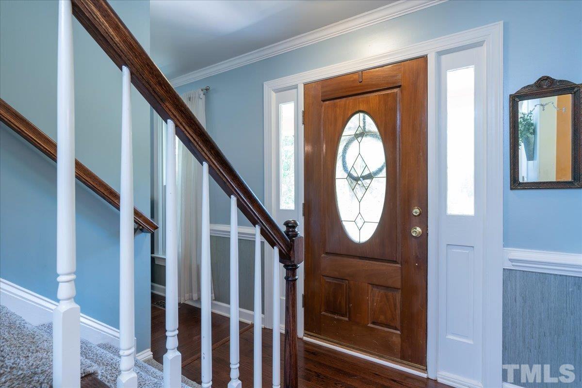 908 Broadhaven Drive Raleigh, NC 27603 - Photo 5 of 33 a view of staircase with a large mirror and a window