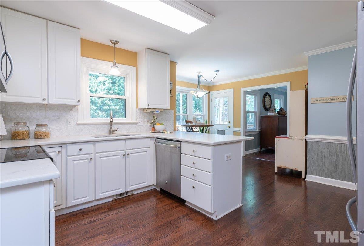 908 Broadhaven Drive Raleigh, NC 27603 - Photo 8 of 33 a kitchen with sink cabinets and wooden floor
