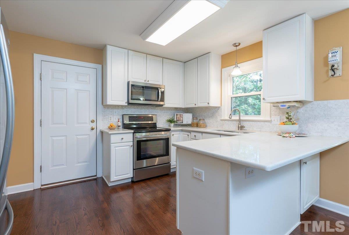 908 Broadhaven Drive Raleigh, NC 27603 - Photo 10 of 33 a kitchen with a sink cabinets a window and a kitchen