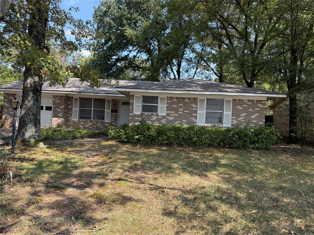 2995 Carson Lane Paris, TX 75460 - Photo 2 of 10 a front view of a house with a yard