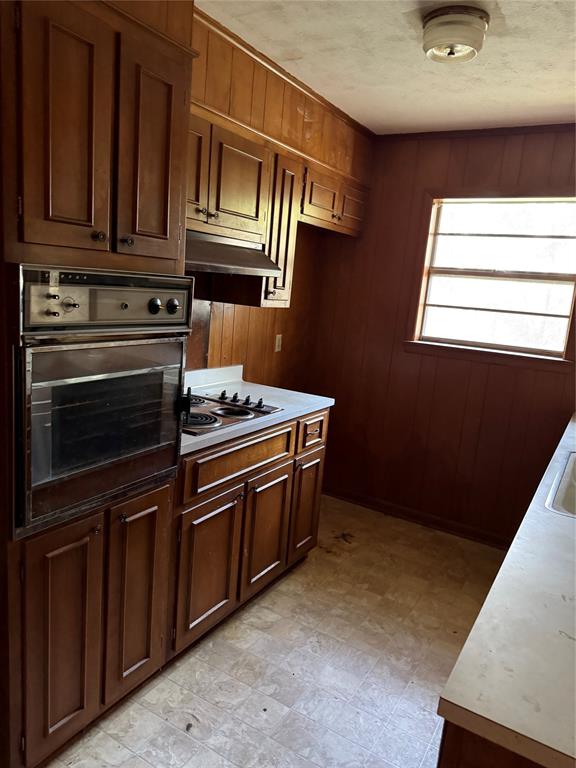 2995 Carson Lane Paris, TX 75460 - Photo 5 of 10 a kitchen with wooden cabinets and a stove top oven