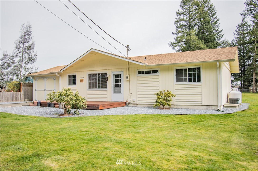 18428 Melon Street Southwest Rochester, WA 98579 - Photo 1 of 19 a house view with swimming pool in front of it