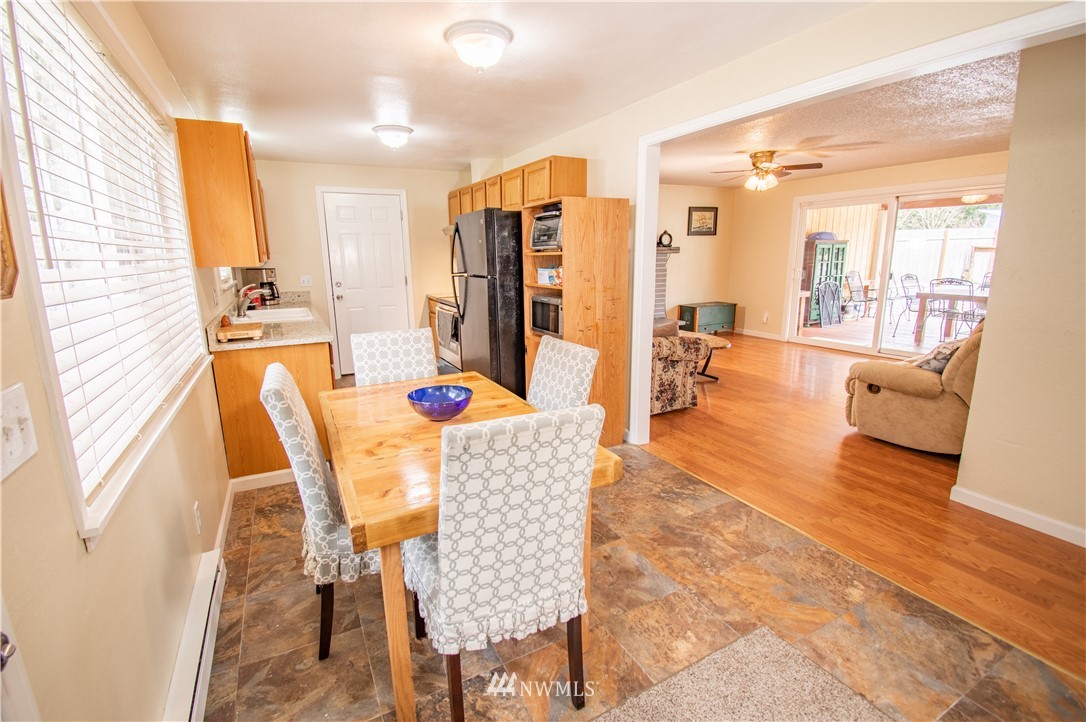 18428 Melon Street Southwest Rochester, WA 98579 - Photo 3 of 19 a dining room with furniture a chandelier and wooden floor