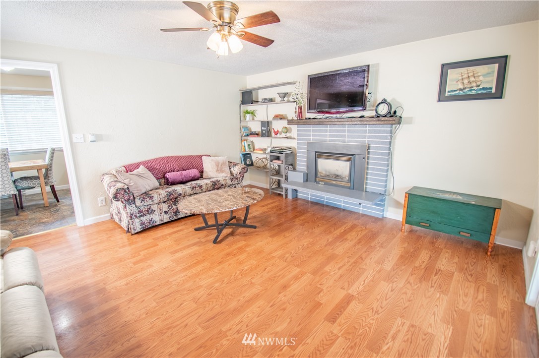 18428 Melon Street Southwest Rochester, WA 98579 - Photo 7 of 19 a living room with furniture and a fireplace