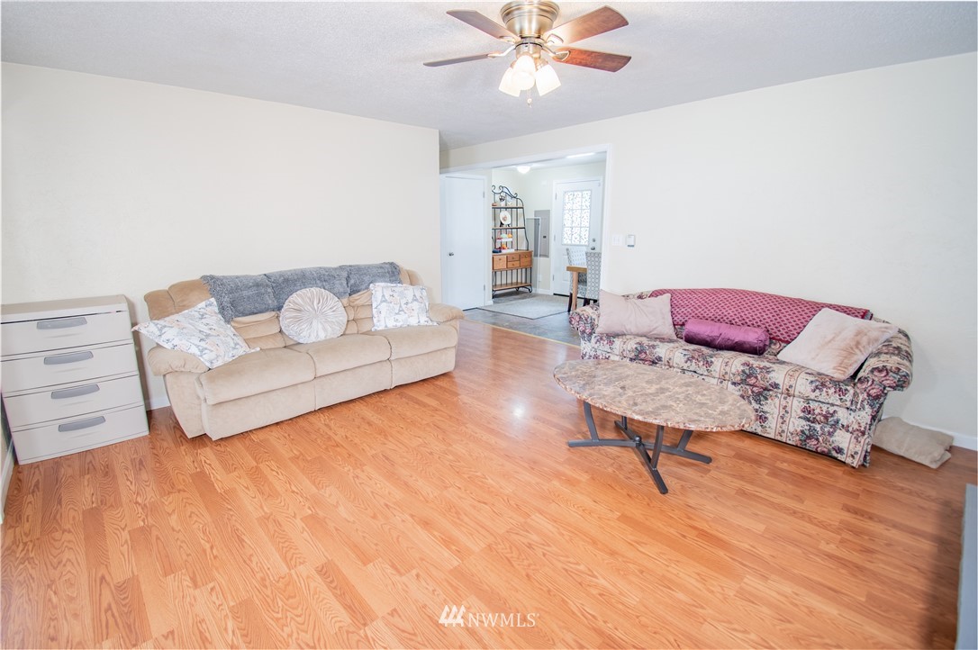 18428 Melon Street Southwest Rochester, WA 98579 - Photo 8 of 19 a living room with furniture and a wooden floor