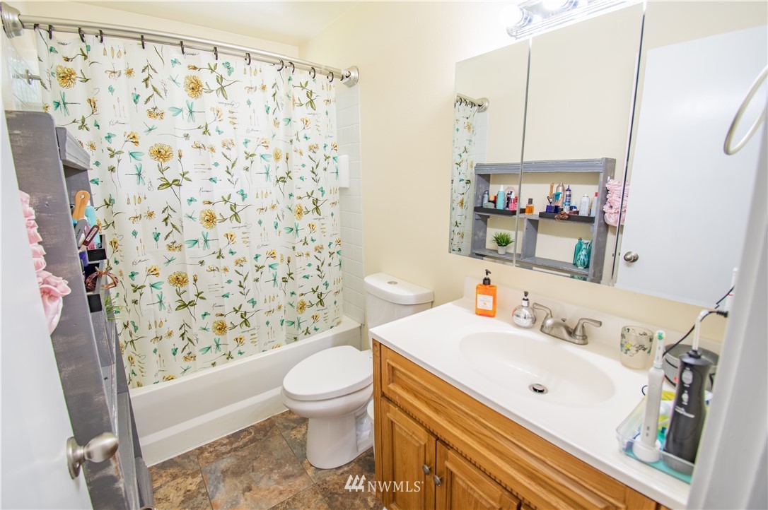 18428 Melon Street Southwest Rochester, WA 98579 - Photo 9 of 19 a bathroom with a sink toilet and shower