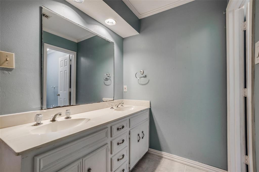 9911 Silver Creek Road Dallas, TX 75243 - Photo 23 of 28 Dual vanity with integrated sinks, brushed nickel faucets, and under-counter storage