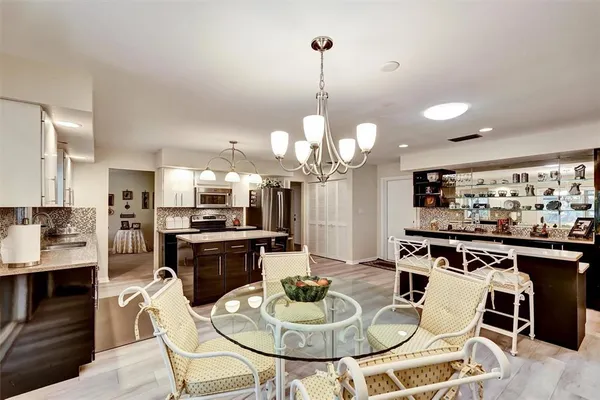 a kitchen with a dining table and chairs