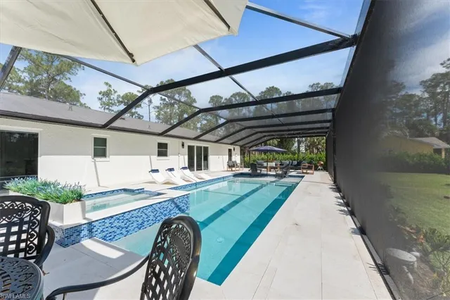 a view of a patio with a table and chairs under an umbrella