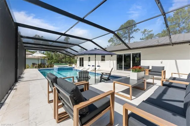 a view of a patio with a table and chairs under an umbrella
